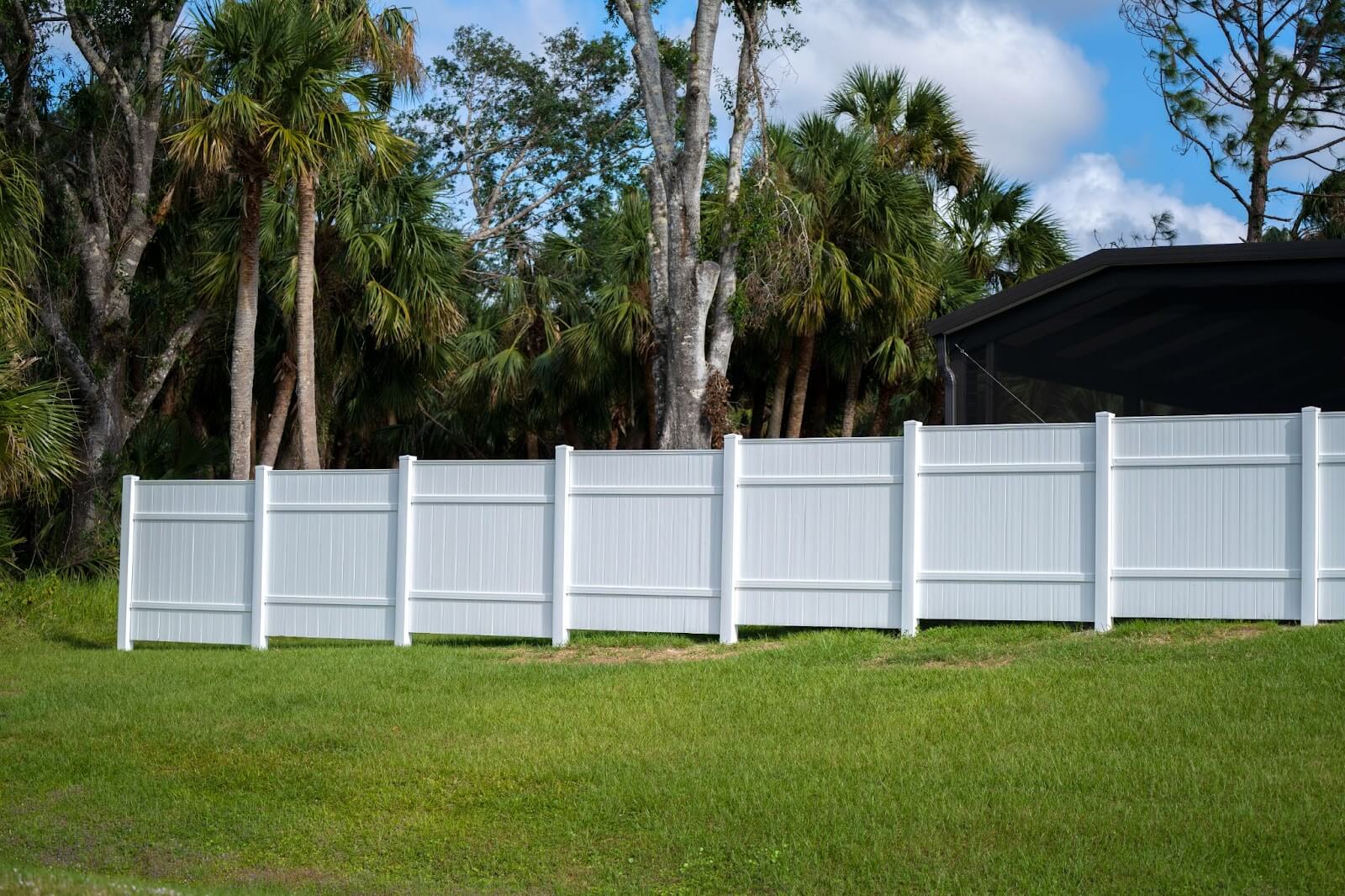 A front view of a white vinyl fence.